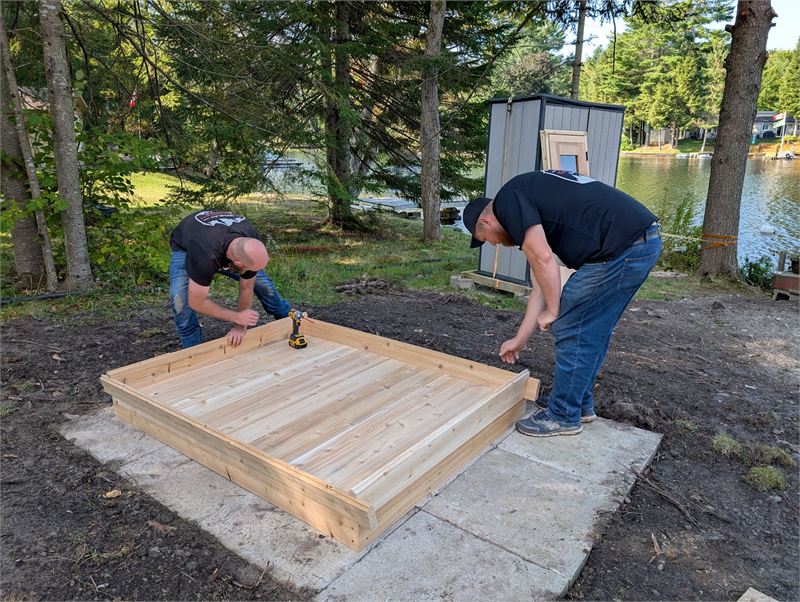 GCS installation team assembling a cedar sauna on site