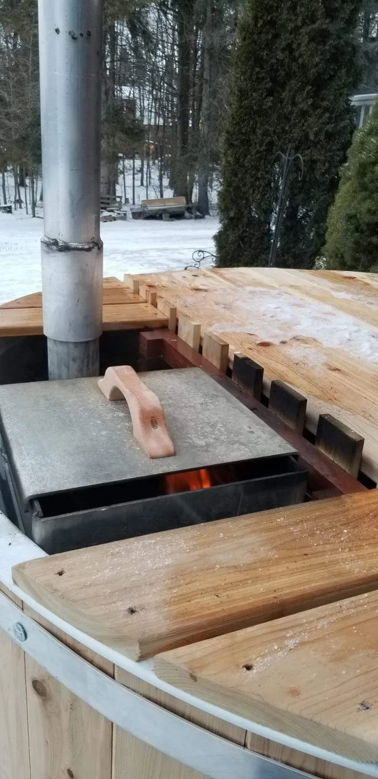 Wood-fired hot tub heater and wooden cover detail